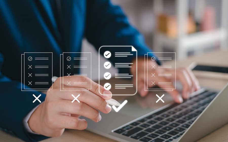 person with laptop and checklists overlay